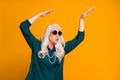 Photo of crazy funky grandma lady music lover senior retro party cool look dancing strange youngster moves wear green