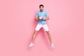 Photo of crazy funky man jump hold clock being late wear blue shirt shorts sneakers isolated on pink color background