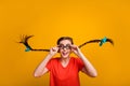 Photo of crazy funny pretty lady student hold spectacles good eyesight long braids blue ribbon bows flight wear freak Royalty Free Stock Photo