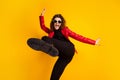 Photo of crazy girl raise leg wear trousers isolated over bright shine color background Royalty Free Stock Photo