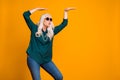 Photo of crazy grandma lady music lover senior retro party cool look dancing strange youngster moves wear green shirt