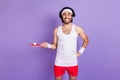 Photo of crazy happy funky young man hold hand ping pong racket smile isolated on violet color background Royalty Free Stock Photo