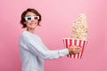 Photo of crazy lady hold popcorn bucket throw food wear 3d glasses blue sweater isolated pink color background