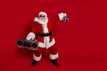 Photo of crazy old man hold boombox glowing ball dance disco wear santa hat costume isolated red color background Royalty Free Stock Photo