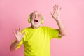 Photo of crazy old man listen music dance arms wear headphones spectacles lime color clothes isolated on pink background Royalty Free Stock Photo