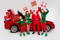 Photo of crazy people santa team north pole workers hold presents wear costume isolated white color background Royalty Free Stock Photo
