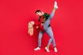 Photo of crazy positive couple dance move lady raise leg wear ugly sweater jeans shoes isolated red color background