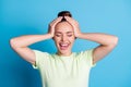 Photo of crazy positive girl touch hands head close eyes isolated over blue color background