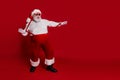 Photo of crazy positive retired man dance disco pull suspenders wear santa hat costume isolated red color background