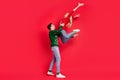 Photo of crazy sporty active couple dance lady jump wear ugly sweater jeans shoes isolated red color background