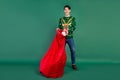 Photo of crazy surprised guy open sack pull present box wear deer ornament sweater isolated green color background