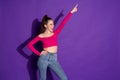 Photo of crazy young lady raise arm pointing finger up shout wear jeans pink uncovered shoulders top isolated purple