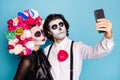 Photo of creepy monster two people man lady cuddle hold telephone make selfie eternal anniversary wear black dress death