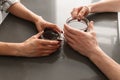 Photo cropped of woman and man sitting at table in flat, while h