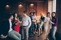 Photo of crowd of working people engaged in business having corporate party with fun and alcohol wearing formally