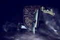 Photo of crown over king knight helmet armor and sword over dark background. Medieval period concept Royalty Free Stock Photo