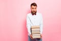 Photo of crying frustrated guy holding heavy stack of books in hands pastel background