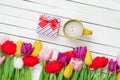 Photo of cup of coffee, cute gift and colorful tulips