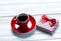 photo of cup of coffee and cute wrapped gift on the wonderful white wooden background