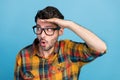 Photo of curious brunet guy look empty space wear eyewear yellow shirt isolated on blue color background