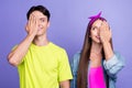 Photo of curious couple palm cover one eye look each other wear pin-up outfit isolated violet color background