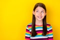 Photo of curious dreamy thoughtful small lady look empty space wear striped shirt isolated yellow color background