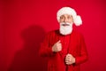 Photo of curious excited successful santa claus look empty space wear x-mas hat suit on red color background Royalty Free Stock Photo