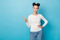 Photo of curious girl buns hairdo indicate finger look empty space wear white sweater isolated blue color background