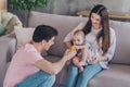 Photo of curious little kid take toy play father game wear casual outfit in comfortable apartment home indoors