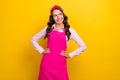 Photo of curious millennial brunette housekipper look empty space lady wear pink shirt apron band isolated on yellow