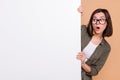 Photo of curious shocked lady look poster information wear specs khaki shirt beige color background