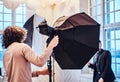 Photo of a curly photographer in a studio