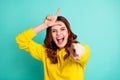 Photo of curly white wavy trendy cheerful charming sweet pretty cute schoolgirl teasing you showing you loser sign Royalty Free Stock Photo