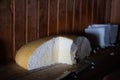 Photo of a cut homemade hard cheese. Gourmet cheese cooked in the mountains of Kartpat. Homemade cheese making