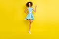 Photo of cute adorable dark skin girl dressed blue clothes smiling showing v-sign isolated yellow color background Royalty Free Stock Photo