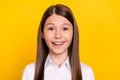 Photo of cute adorable excited schoolgirl beaming smile wear white shirt isolated yellow color background