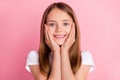 Photo of cute blond small girl hands face wear white t-shirt isolated on pink color background Royalty Free Stock Photo