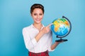 Photo of cute blond young lady point globe wear shirt isolated on blue color background Royalty Free Stock Photo