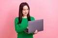 Photo of cute busy woman wear green sweater typing emails twitter telegram facebook emtpy space isolated pink color