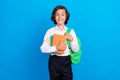 Photo of cute charming school boy wear formal outfit backpack smiling holding copybooks  blue color background Royalty Free Stock Photo