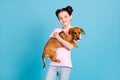 Photo of cute charming school girl wear pink t-shirt smiling holding arms hands small friend isolated blue color