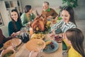 Photo of cute cheerful family eating holiday turkey sitting table smiling communicating indoors house room Royalty Free Stock Photo