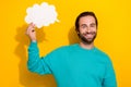 Photo of cute cheerful guy dressed teal outfit smiling mind speaking cloud empty space isolated yellow color background