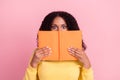 Photo of cute excited dark skin woman wear yellow sweater spectacles holding copybook cover lips face isolated pink