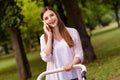 Photo of cute excited mother dressed casual clothes walking buggy little son communicating modern device outdoors Royalty Free Stock Photo