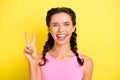 Photo of cute excited young woman pigtails wear tank top showing v-sign isolated yellow color background