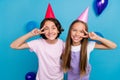 Photo of cute funky friends wear casual outfits birthday headwear showing v-signs cover eyes isolated blue color Royalty Free Stock Photo