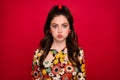 Photo of cute funky woman wear flower print dress bloated cheeks lips pouted plump isolated red color background