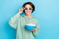 Photo of cute funny lady dressed green pullover sunglass holding pop corn plate isolated blue color background