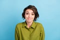 Photo of cute funny lovely lady short hairstyle childish guilty look camera girlish face wear green shirt isolated blue
